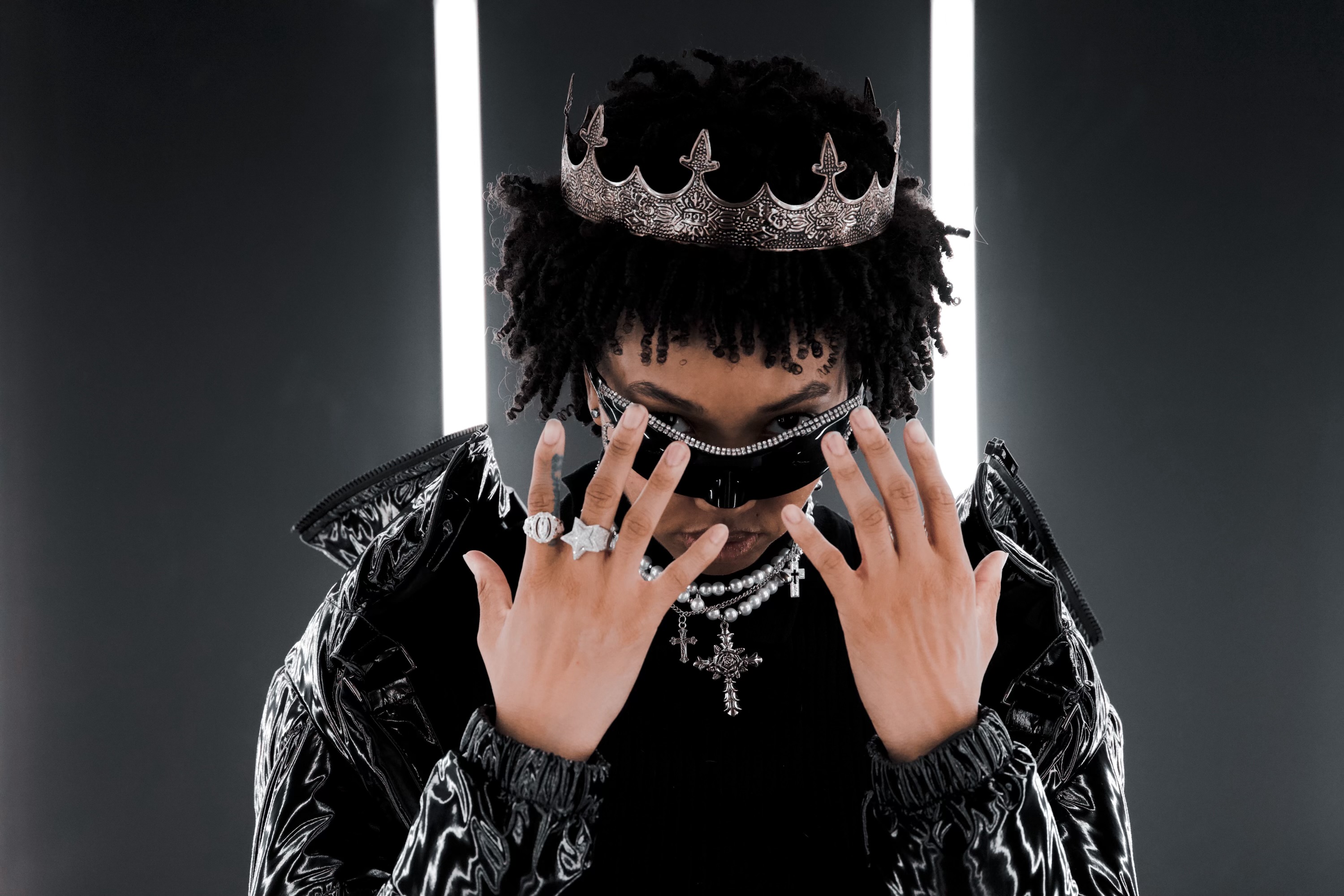 Indika Sam wearing a crown and futuristic sunglasses
